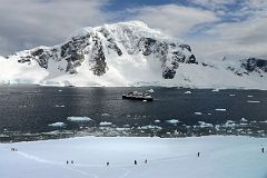 12D Tourists Descend From The Top Of Danco Island To Reboard The Ship With Mount Britannia On Ronge Island Behind On Quark Expeditions Antarctica Cruise